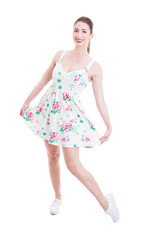 Young lady showing her summer dress as studio posing