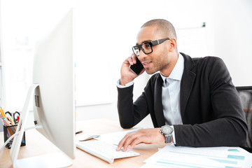 Office worker calling on the phone and reading business document