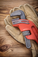 Safety gloves monkey wrench on wood board construction concept