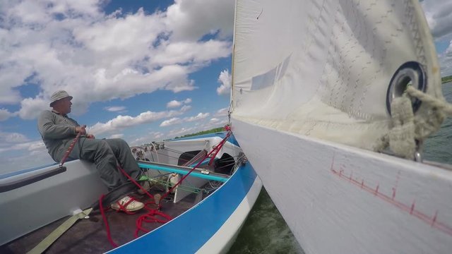 man drives sports yacht, cockpit yacht close-up on speed