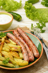 Grilled white sausages with roasted potatoes.