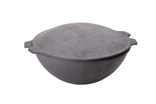 traditional cast iron spherical cauldron isolated on white