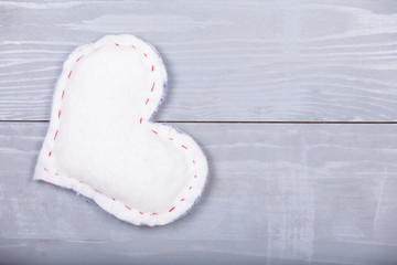 White homemade heart natural grey wooden background.