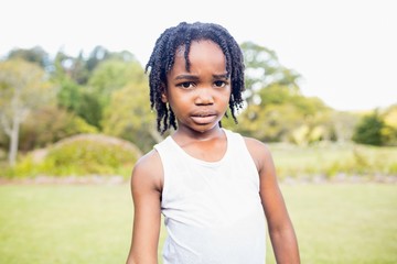 Kid posing at camera during a sunny day 