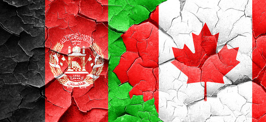 Afghanistan flag with Canada flag on a grunge cracked wall