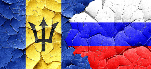 Barbados flag with Russia flag on a grunge cracked wall