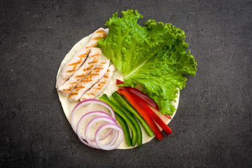 Mexican fajitas ingredients on slate background

