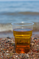 Glass of beer on the sea