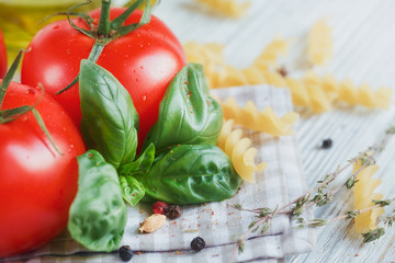 Italian food background, with tomatoes, basil, pasta, olive oil,