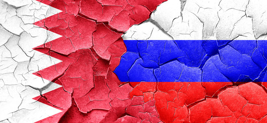 Bahrain flag with Russia flag on a grunge cracked wall