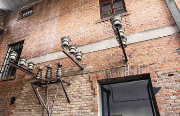 Brick wall of historical power station building with windows