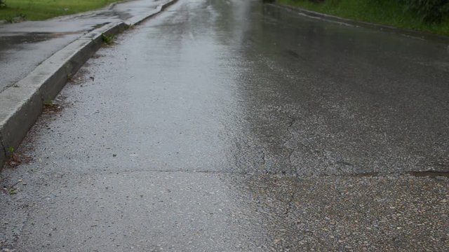 Rain is falling on an empty road 