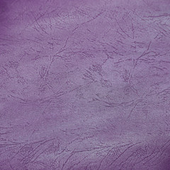 Purple leather textured background with light stains.