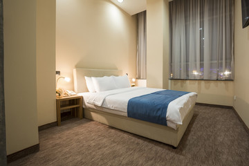 Fototapeta na wymiar Elegant hotel bedroom interior