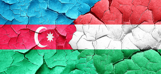 Azerbaijan flag with Hungary flag on a grunge cracked wall
