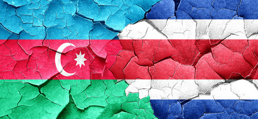 Azerbaijan flag with Costa Rica flag on a grunge cracked wall