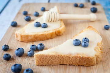 Sandwiches with cream honey and blueberries