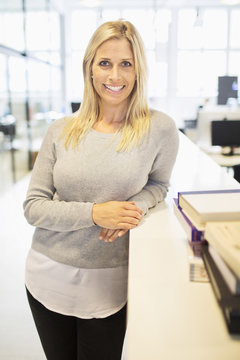 Portrait of smiling mid adult woman in office