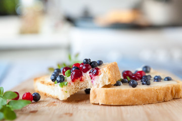 Sandwiches with cream honey, blueberries and cranberries