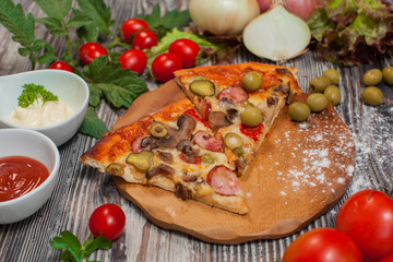 Fototapeta na wymiar pizza with mushrooms and pepperoni , tomatoes