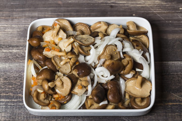 Marinated mushrooms with onion on white plate