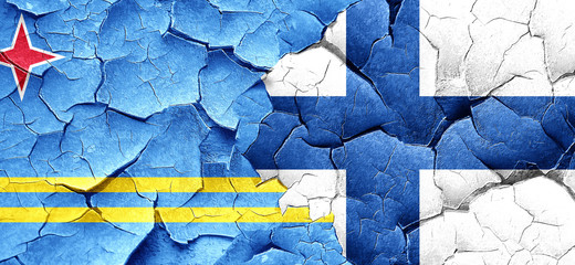 aruba flag with Finland flag on a grunge cracked wall