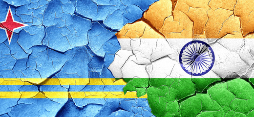 aruba flag with India flag on a grunge cracked wall