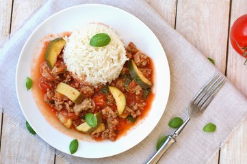 Spicy mincemeat with tomatoes, basil and zucchini with basmati rice