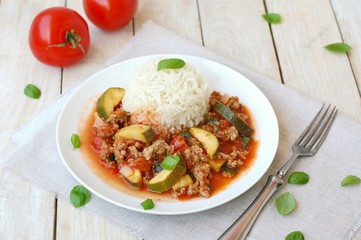 Spicy mincemeat with tomatoes, basil and zucchini with basmati rice