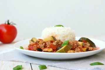 Spicy mincemeat with tomatoes, basil and zucchini with basmati rice