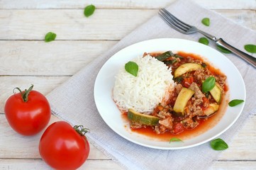 Spicy mincemeat with tomatoes, basil and zucchini with basmati rice