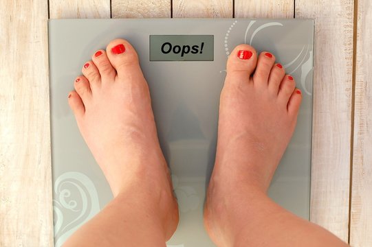 Feet on scales with text oops