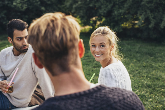 Portrait of happy woman enjoying rooftop party with friends