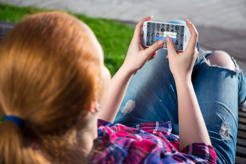 mobile internet concept - smart phone in teenage girl hands