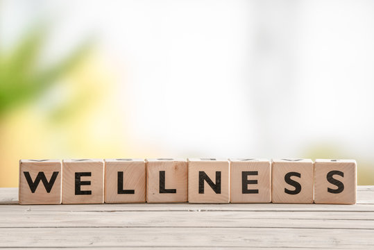 Wooden sign with the word wellness