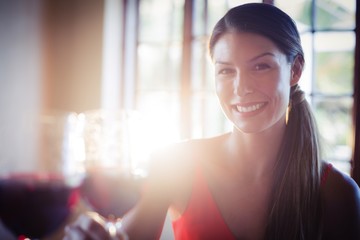 Happy young woman toasting wine glass