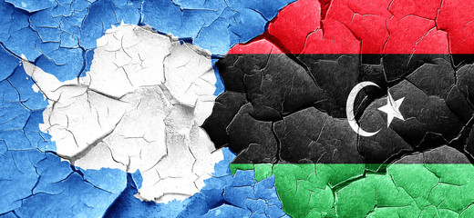 antarctica flag with Libya flag on a grunge cracked wall