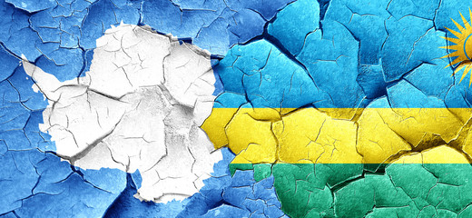 antarctica flag with rwanda flag on a grunge cracked wall