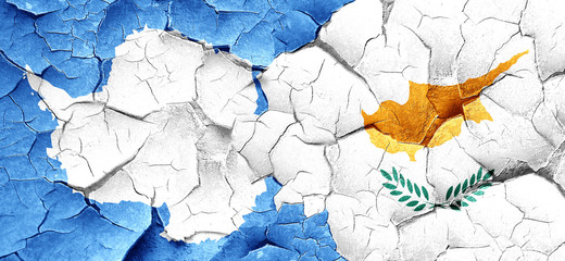 antarctica flag with Cyprus flag on a grunge cracked wall