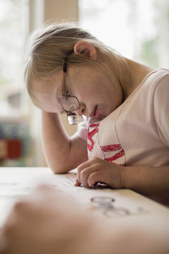 Girl with down syndrome studying at table