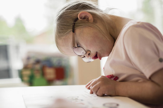 Girl  with Down syndrome reading