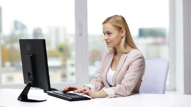 young businesswoman with computer typing at office