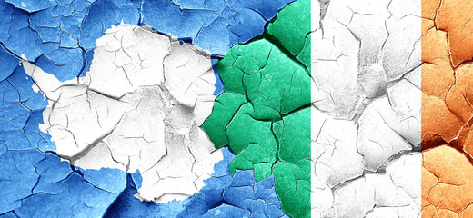 antarctica flag with Ireland flag on a grunge cracked wall