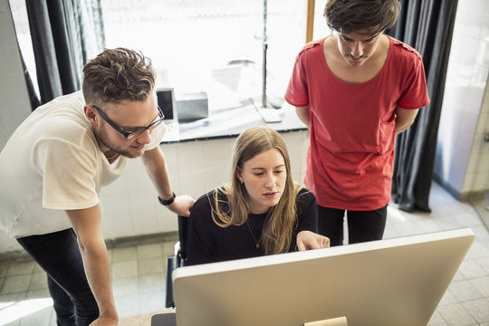New business team working on computer in creative office