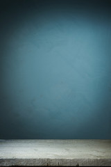 Background with wooden table and grunge blue wall