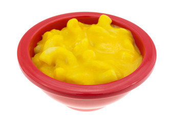 Small bowl of mac and cheese isolated on a white background side view.