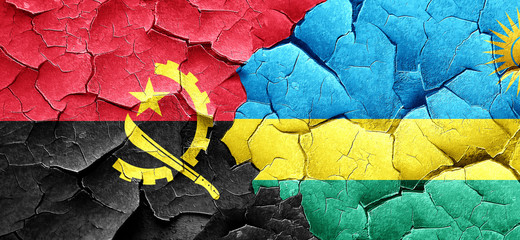 Angola flag with rwanda flag on a grunge cracked wall