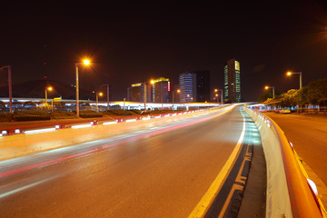 Fototapeta na wymiar Empty road surface with city buildings of night scene