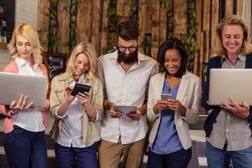 Portrait of a team of hipsters with multimedia tools