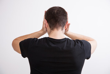 Young man touching his temples and remembering something